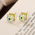 Macro view of gold-plated evil eye stud earrings with cubic zirconia and colorful enamel - Blue White and Yellow-Green Evil Eye (44241)