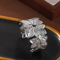 Elegant silver open cuff bracelet featuring a layered leaf and floral engraved design - Silver Embossed Foliage