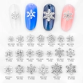 Macro detail of 20 silver snowflake alloy nail charms with rhinestones in grid layout - Hollow Snowflake Style (8650) / Silver
