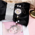 Detail view of a long pearl necklace with a luxury daisy floral pendant on black satin - Gold Daisy Style (21# Necklace)