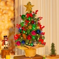 Close-up of 60cm mini Christmas tree with red berries, pine cones, and warm LED lights - SYT311