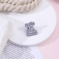 Purple enamel badge with 'smile to the world' text on a stylish decorative display - C2013-1 smile to the world