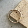 Detail of high-elastic beige hair tie with a matte gold metal cylinder fastener - Off White