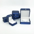Detail of navy blue crown jewelry boxes with white interior for rings and necklaces - Blue