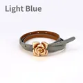 Slim light blue leather belt for women featuring a decorative golden rose flower buckle - Light Blue / 105cm