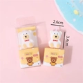 White teddy bear birthday candle with red bow in a yellow gift box, size 3.4cm x 2.6cm - Box Packaging / White
