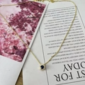 Golden necklace featuring a round dark blue gemstone pendant with white zircon halo - September Royal Blue