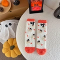 Detail of coral fleece Halloween socks with pumpkin and ghost patterns on plush background - One Size / Home White Style