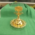 Detail of golden metal incense burner featuring Saudi emblem with palm tree and swords - Palm Tree Top C