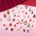 Christmas alloy enamel charms set featuring Santa Claus, trees, and wreaths on pink background - Set of 35 Assorted