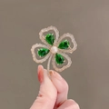 Elegant gold four-leaf clover brooch with emerald green stones and a white pearl accent - 392# Clover