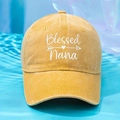 Detail of Blessed Nana embroidery on yellow washed cotton baseball cap with blue water background - Yellow