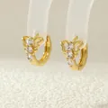 Macro shot of 18K gold bow butterfly earrings with cubic zirconia on clear stand - ER0951-A (Gold Hollow Butterfly)