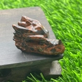 Deep red dragon head natural stone carving on wooden base with detailed texture - Mahogany Obsidian