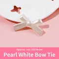 Macro shot of 20x34mm pearl white resin bowknot bead with soft luster on a decorative tray - 02-Pearl White Cross Knot-20X34mm
