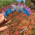 Detail of pink-blue gradient crystal crown with triple moon symbol in hand - Blue & Red Crystal with Triple Moon