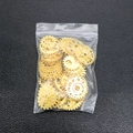 Macro shot of assorted golden steampunk gear charms for DIY resin molds and crafts - Gold Metal Gears 50g