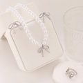 Detailed set of silver bow jewelry featuring white pearl necklace and matching earrings - Silver Bow 3-Piece Set (08)