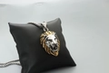 Vintage lion head pendant necklace with gold mane and silver face on display pillow - Fashion Two-tone Gold
