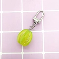 Detailed view of a green mini carambola keychain with silver D-ring and chain - Starfruit/Green