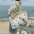Off-white canvas tote bag with rabbit and floral illustration on a scenic beach background - Garden Princess