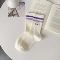Cream crew socks with purple double stripes and Smile embroidery in a cozy flat lay - One Size / White/Purple Stripes
