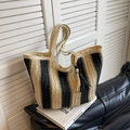 Vertical striped straw tote bag in black and beige with decorative tassel detail - 42*15*28cm / Off-white