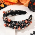Detail of Halloween knot headband with orange pearls and silver spider web patterns - Knotted Spider Web Black Style With Pearls