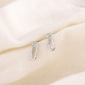 Minimalist S925 sterling silver paperclip stud earrings on a beige linen fabric base - Silver