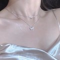 Detail of elegant silver butterfly layered necklace on model collarbone area - Butterfly Dance Layered Necklace