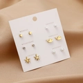 6-pair set of gold-toned pearl and rhinestone stud earrings on a weekly card display - Gold Pearl Dolphin Leaf
