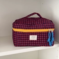 Portable quilted plaid toiletry bag with red and blue checkered pattern and yellow zipper - Red