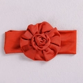 Soft red infant headband featuring a handmade large fabric rose flower on a neutral surface - Rose Red