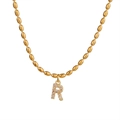 Golden rice bead necklace featuring a sparkling zircon-studded letter R pendant charm - Letter R