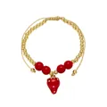 Detail of beaded gold bracelet featuring red strawberry pendant and adjustable cord - Strawberry Pendant (D)