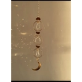 Golden suncatcher with crystal prisms and moon pendant creating rainbow light effects - Moon Style