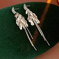 Silver tassels leaf earrings displayed on dark green velvet with sparkling zircon details - Silver