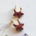 Macro view of gold-trimmed burgundy enamel star earrings with elegant finish - Mosquito Coil Ear Clip / Burgundy