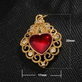 Macro detail of gold-plated heart pendant with red gem and 25mm height dimensions - Hollow Heart Red Gem Style (A0038)