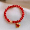 Macro shot of red beaded bracelet featuring a gold rocking horse charm with zircon stones - Red Beaded Enamel Pony (Style 6)