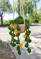 Detailed view of hand-crocheted green hanging plant with yellow flowers for car interior - No.2 (Beige Pot Round Leaves Yellow Flower)