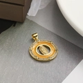 Close-up of a gold-plated Virgin Mary pendant with orange enamel and zircon accents - Orange Round
