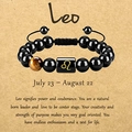 Adjustable Leo zodiac bracelet with tiger eye stone and black beads on parchment paper - Leo