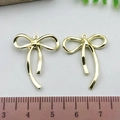 Pair of golden bowknot alloy pendants with ruler measurement for jewelry making - Classic Bowknot - KC Gold (21392)
