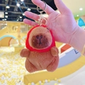 Detailed view of capybara plush keychain featuring a soft red strawberry hood and gold clasp - Strawberry Hat Dark Brown + Gold Clip