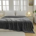 Deep grey flannel blanket with 3D embossed butterfly pattern shown on a cozy bed - Dark Gray