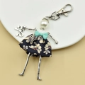 Detailed close-up of a handmade doll keychain with a blue floral dress and pearl head - 03-Blue Floral Dress Doll