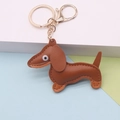 Caramel brown leather dachshund keychain with golden hardware on minimalist background - Dachshund / Small Coffee Keychain Style