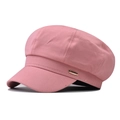 Detailed side view of pink octagonal baker boy hat featuring a gold metallic logo plate - One Size / Beige