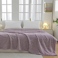 Thick lavender flannel blanket with embossed butterfly patterns on a cozy bed - Purple